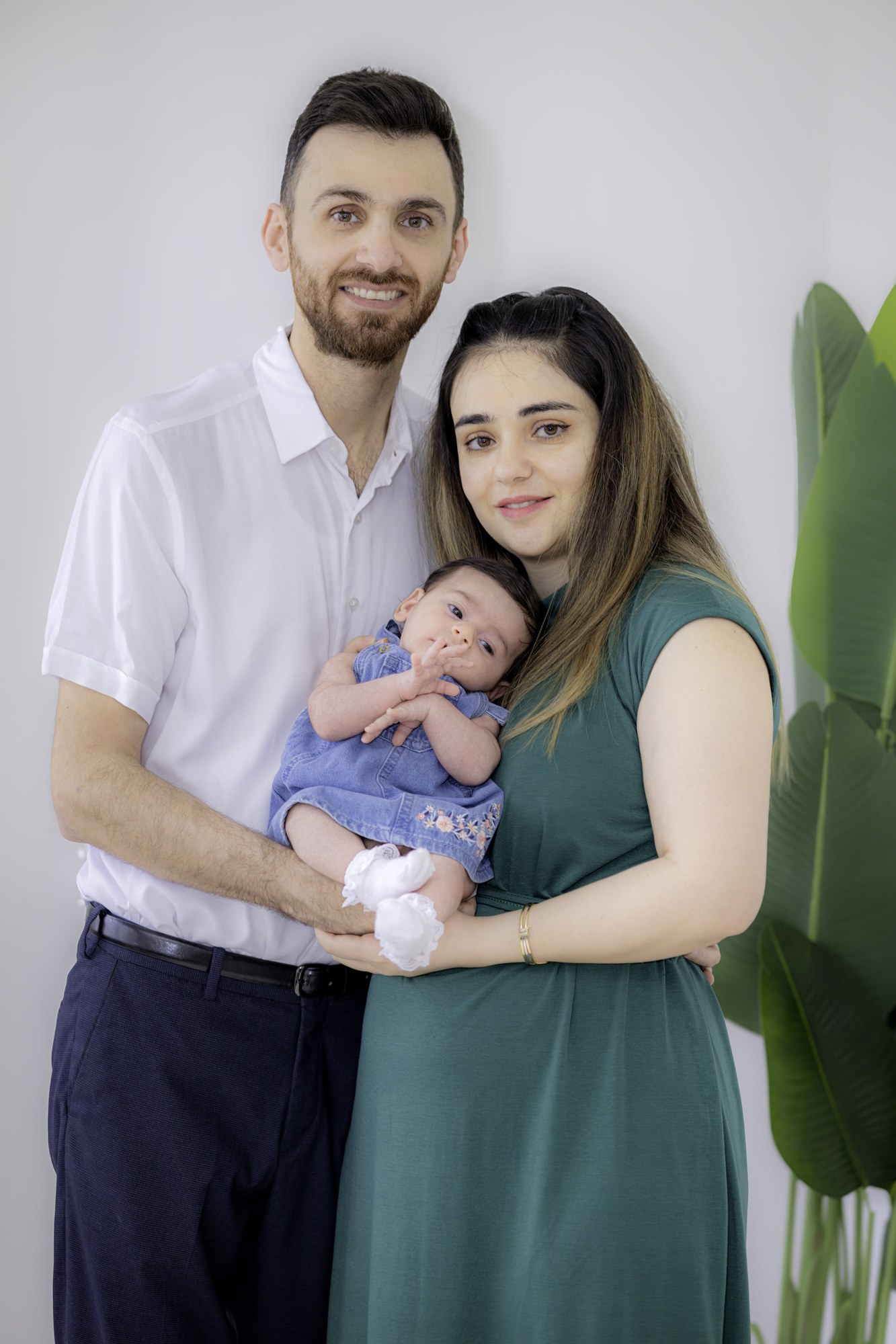 Parents holding their newborn baby for a family portrait